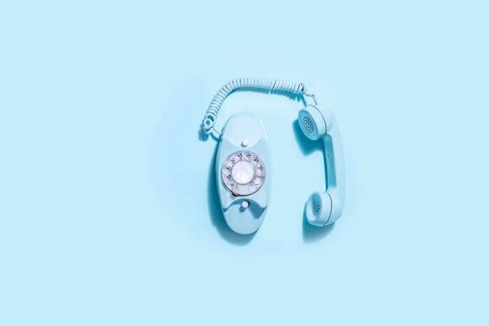 Blue vintage telephone set against a blue background