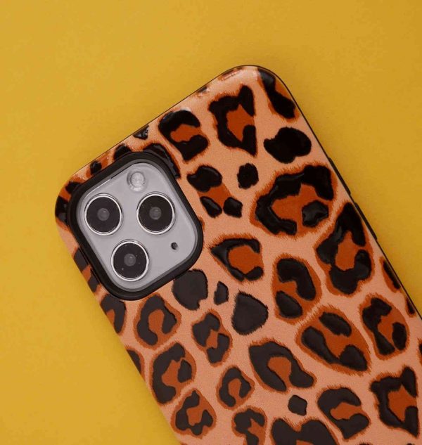 Phone case with brown leopard print design set against a yellow background